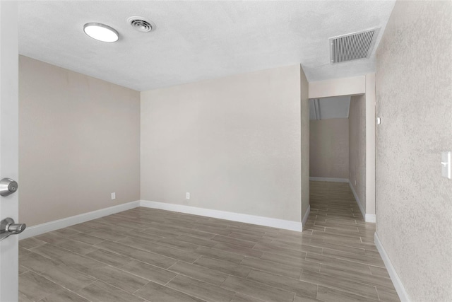 empty room featuring a textured ceiling