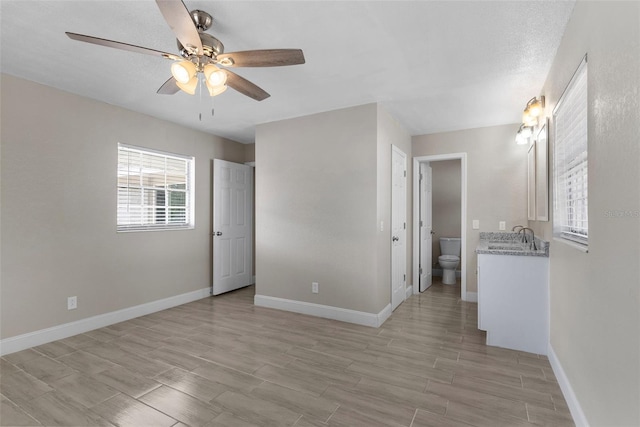 empty room featuring sink and ceiling fan