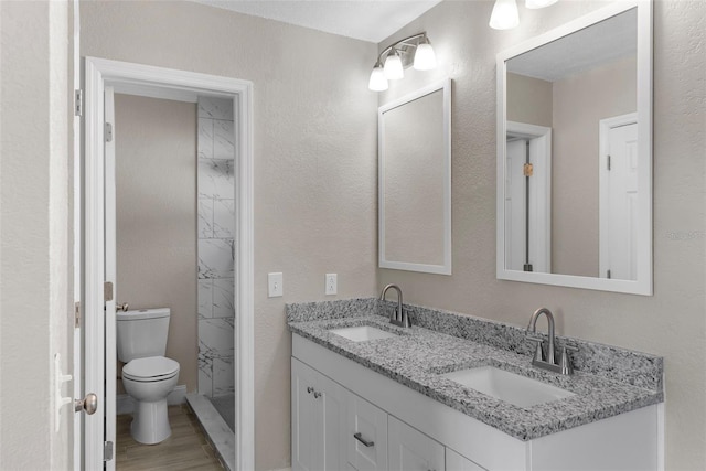 bathroom featuring vanity, hardwood / wood-style floors, and toilet