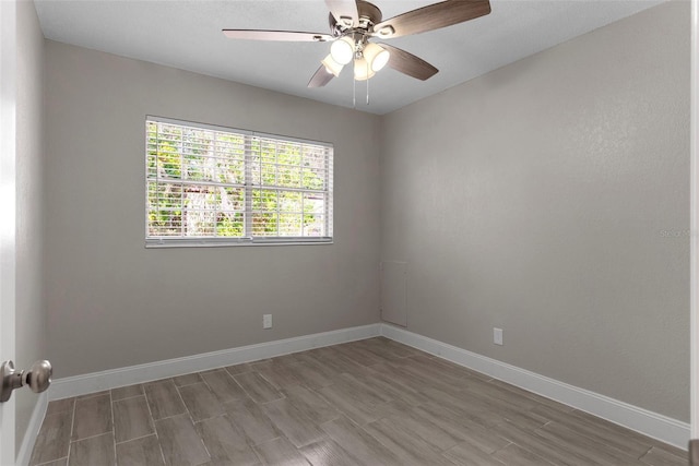 empty room with ceiling fan and wood-type flooring