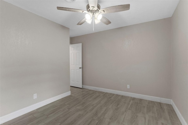 spare room featuring light hardwood / wood-style flooring and ceiling fan