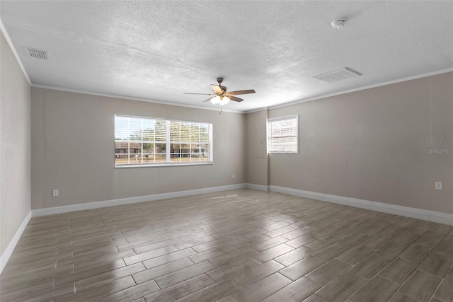 spare room with ceiling fan, ornamental molding, dark hardwood / wood-style flooring, and a textured ceiling