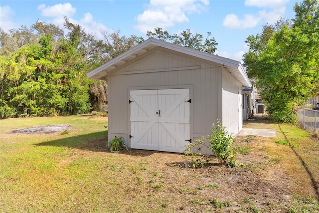 view of outbuilding featuring a lawn