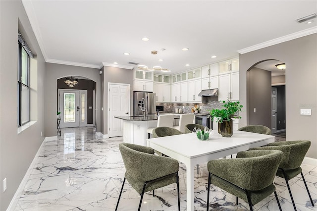 dining space featuring ornamental molding