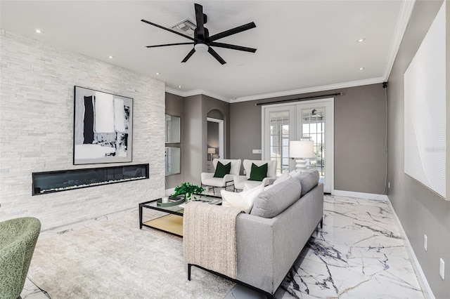 living room featuring crown molding, ceiling fan, a stone fireplace, and french doors