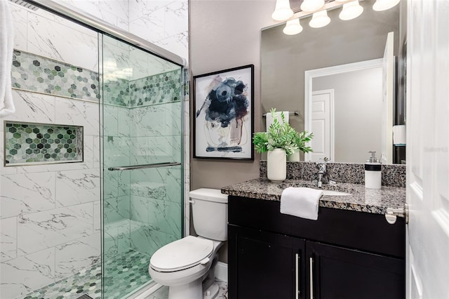 bathroom with vanity, toilet, and a shower with shower door