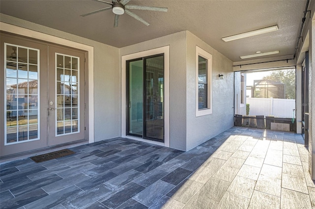 view of patio featuring french doors and ceiling fan