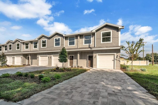 view of front of house featuring a garage and a front lawn