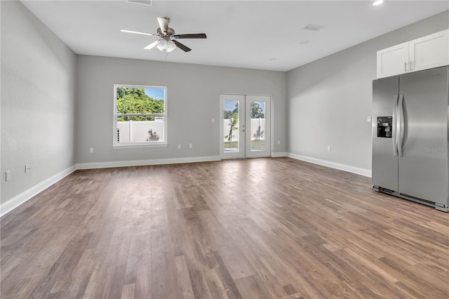 unfurnished living room with ceiling fan and light wood-type flooring