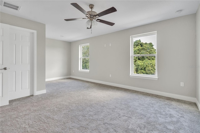 unfurnished room featuring light colored carpet and ceiling fan