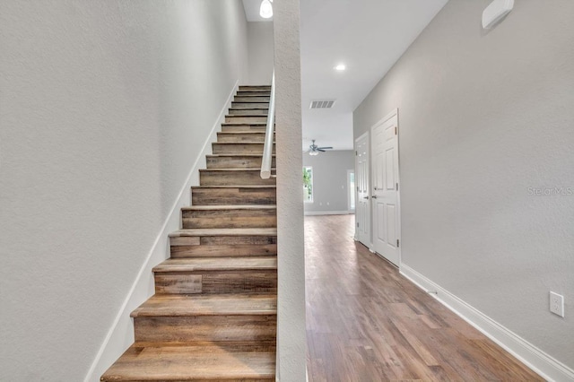 stairs featuring wood-type flooring