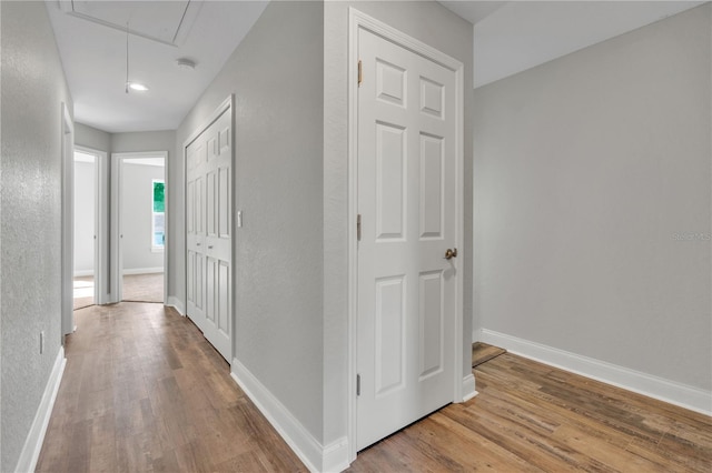 hall with light hardwood / wood-style floors