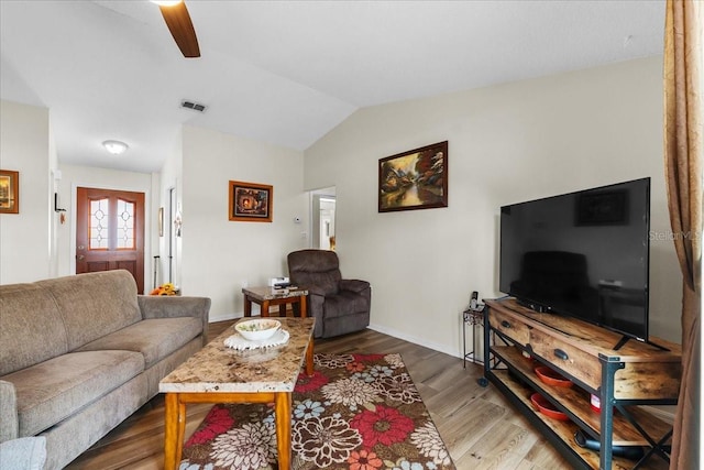 living room featuring wood-type flooring, lofted ceiling, and ceiling fan