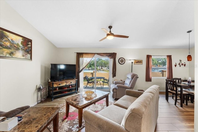 living room with ceiling fan and light hardwood / wood-style flooring