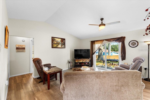 living room with ceiling fan, lofted ceiling, and light hardwood / wood-style flooring