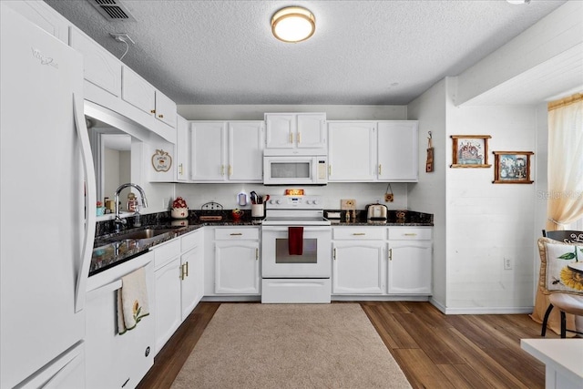 kitchen featuring white appliances, dark hardwood / wood-style flooring, sink, and white cabinets