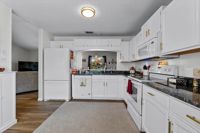 kitchen featuring sink, white appliances, dark wood-type flooring, white cabinetry, and a textured ceiling