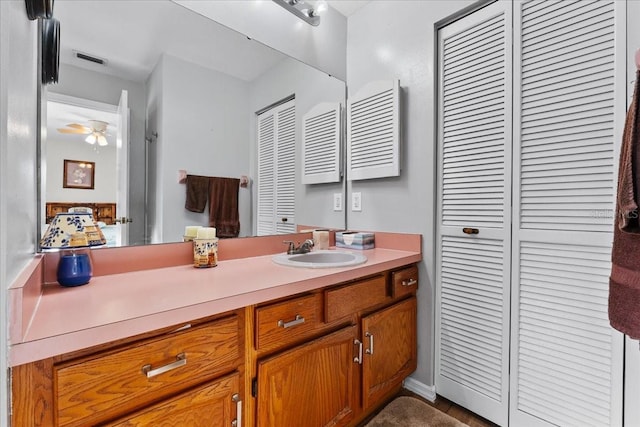 bathroom with ceiling fan, vanity, and radiator heating unit