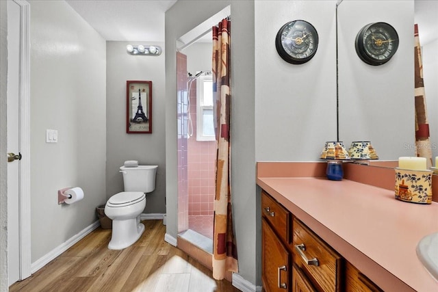 bathroom featuring a shower with curtain, vanity, toilet, and hardwood / wood-style floors