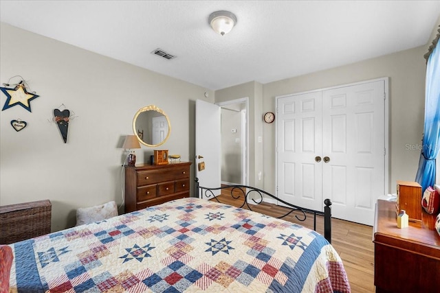 bedroom featuring light hardwood / wood-style floors and a closet