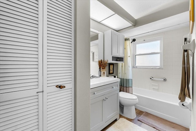 full bathroom with vanity, wood-type flooring, shower / bath combo with shower curtain, and toilet