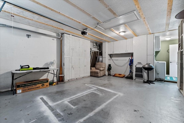 garage with a garage door opener and washer / dryer