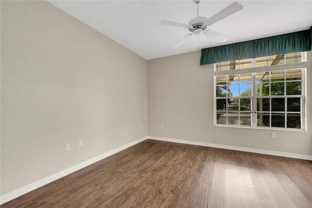 unfurnished room featuring ceiling fan, baseboards, and wood finished floors