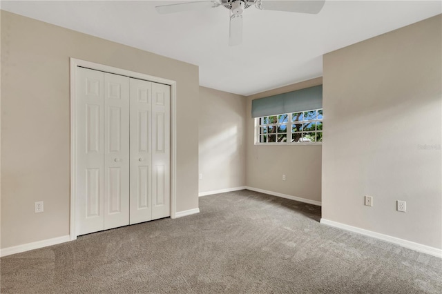 unfurnished bedroom with a closet, carpet flooring, a ceiling fan, and baseboards