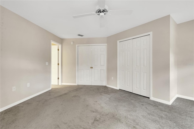 unfurnished bedroom with carpet floors, visible vents, baseboards, and a ceiling fan