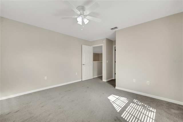 unfurnished bedroom featuring a ceiling fan, carpet, visible vents, and baseboards