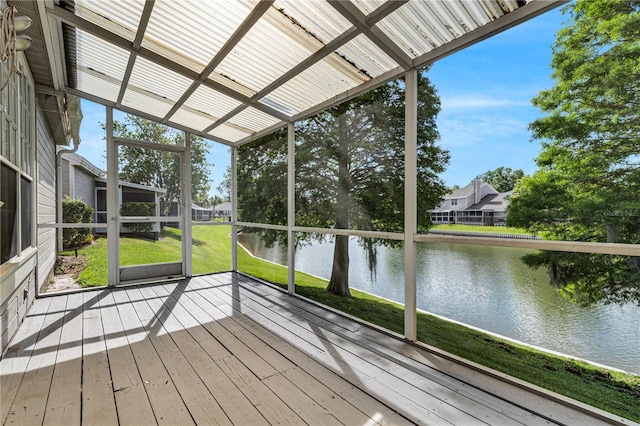 unfurnished sunroom featuring a water view