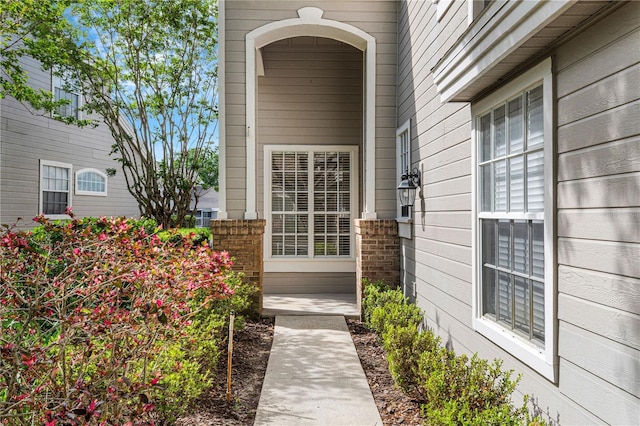 doorway to property featuring brick siding