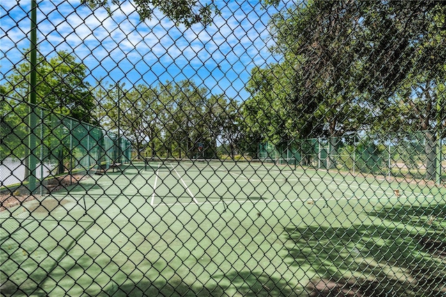 view of tennis court with fence