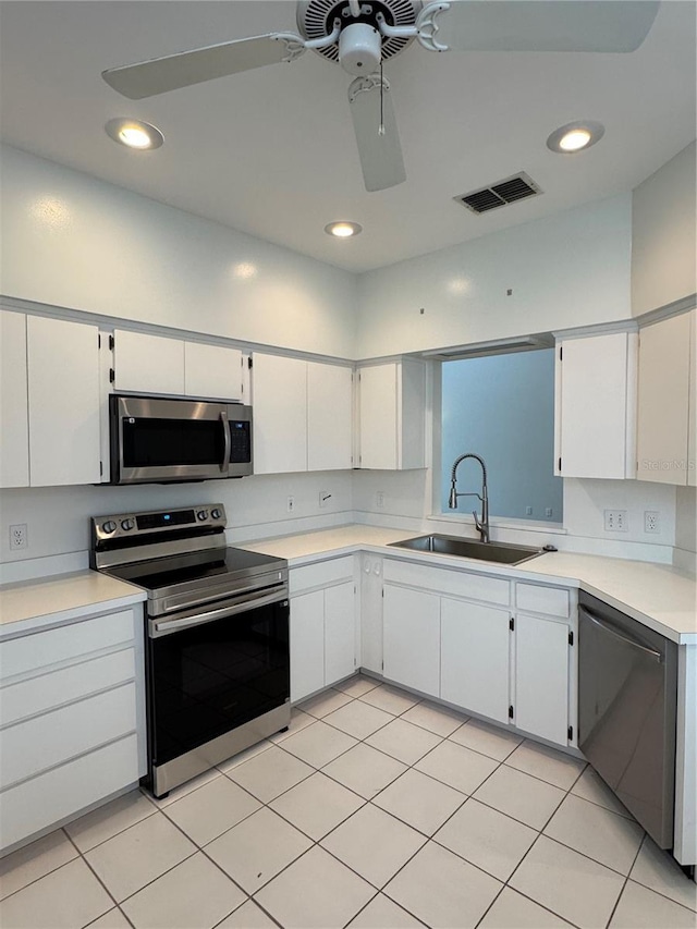 kitchen featuring visible vents, white cabinets, appliances with stainless steel finishes, light countertops, and a sink