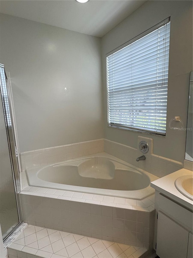 full bath featuring a garden tub and vanity