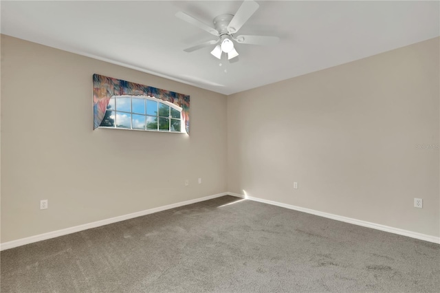 spare room featuring a ceiling fan, carpet, and baseboards