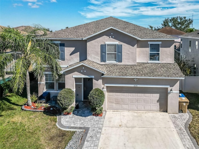 view of front property with a garage and a front lawn