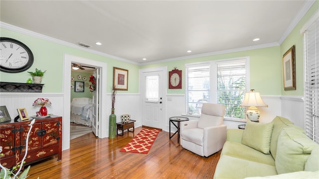 living room with hardwood / wood-style floors and ornamental molding