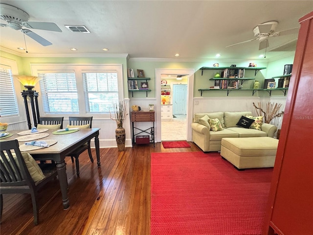 living room with crown molding, dark hardwood / wood-style floors, and ceiling fan