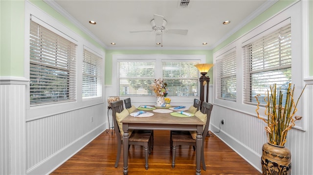 dining space featuring ceiling fan, ornamental molding, and dark hardwood / wood-style floors