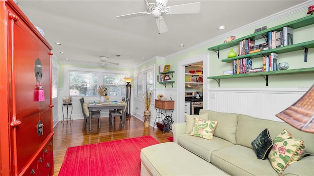 living room with ornamental molding, dark hardwood / wood-style floors, and ceiling fan