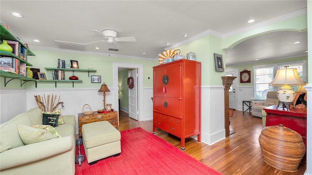 living room with crown molding, hardwood / wood-style flooring, and ceiling fan