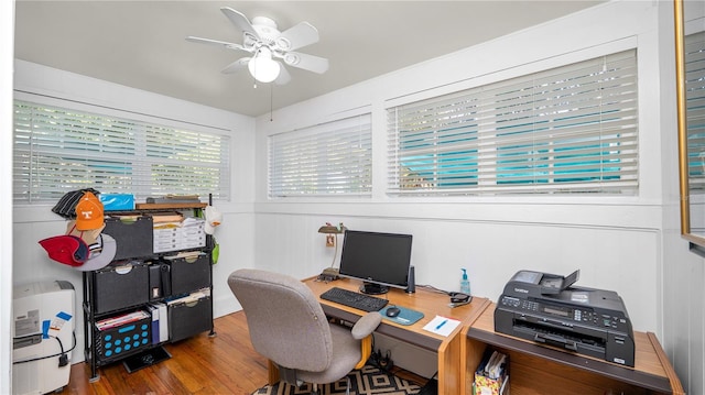 home office with wood-type flooring and ceiling fan