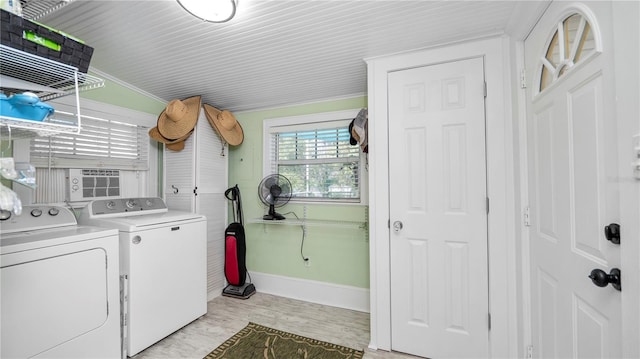 laundry area featuring crown molding, washer and clothes dryer, and light wood-type flooring