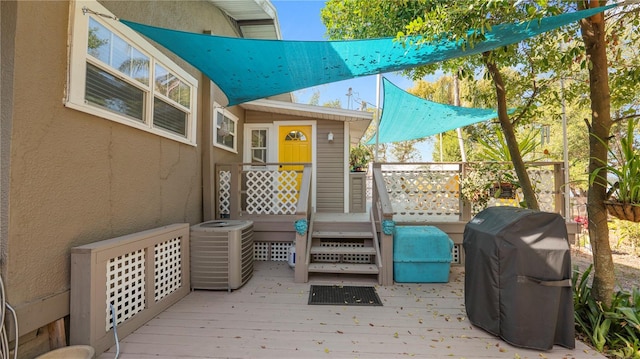 deck with a grill and central AC unit