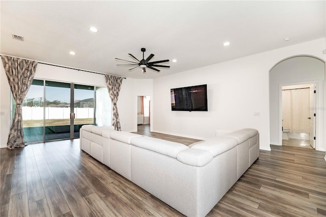 living room with hardwood / wood-style flooring and ceiling fan