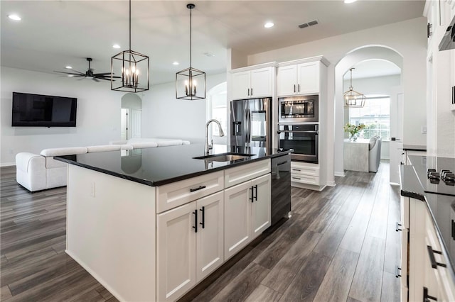 kitchen featuring stainless steel appliances, sink, and white cabinets