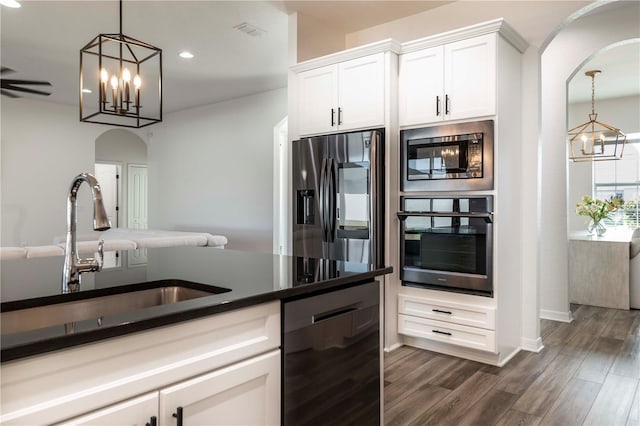 kitchen with sink, decorative light fixtures, appliances with stainless steel finishes, dark hardwood / wood-style flooring, and white cabinets