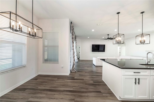 kitchen featuring pendant lighting, ceiling fan, dark hardwood / wood-style flooring, and white cabinets