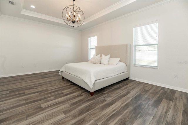 bedroom featuring multiple windows, a tray ceiling, and dark wood-type flooring